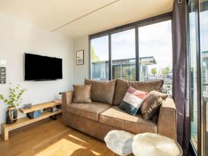 a living room with a couch and a tv at Wave in Volendam