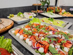a buffet with several plates of food on a table at Willa Bliźniak 2 - 300m od Plaży Śniadanie W Cenie Pobytu in Karwia