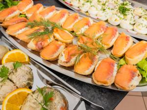 a buffet of food with salmon sandwiches and vegetables at Willa Bliźniak 2 - 300m od Plaży Śniadanie W Cenie Pobytu in Karwia +61 photos