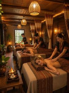 a group of people laying on beds in a room at OH Pu Luong Homestay in Làng Bang