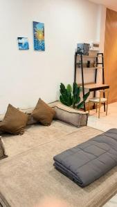 a living room with a couch on a rug at Hatyai marina Villa in Ban Khlong Hae