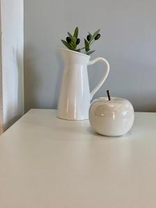 a white vase and a candle on a table at A & D Houses in Patra