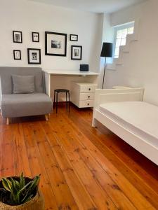 a bedroom with a bed and a desk and a chair at A & D Houses in Patra