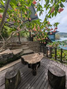 a table and two stools on a wooden deck at Brisk Ella Retreat in Ella