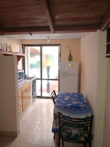 a small kitchen with a table and a refrigerator at Hospedaje Nely in San Vicente