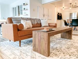 a living room with a couch and a coffee table at Modern Mountainside Chalet in Steamboat Springs