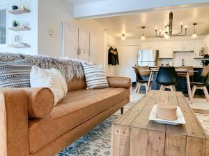 a living room with a couch and a table at Modern Mountainside Chalet in Steamboat Springs +57 photos