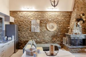 a kitchen with a stone wall with a fireplace at Penelopes Rhapsody Resort in Missolonghi