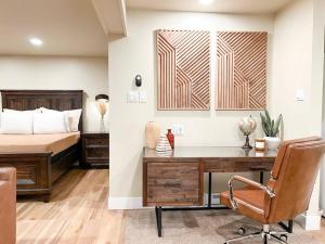 a bedroom with a bed and a desk and a bed at Cozy Mountainside Den in Steamboat Springs