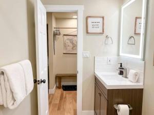 a bathroom with a sink and a mirror at Cozy Mountainside Den in Steamboat Springs