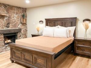 a bedroom with a large bed with a fireplace at Cozy Mountainside Den in Steamboat Springs