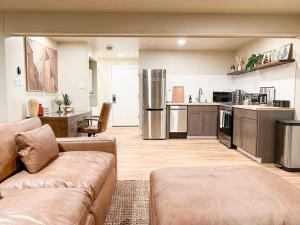 a living room with a couch and a kitchen at Cozy Mountainside Den in Steamboat Springs +8 photos
