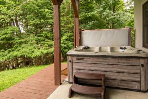 a sink and a chair on a patio at Serenity Summit in Banner Elk