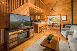 a living room with a large flat screen tv at Serenity Summit in Banner Elk