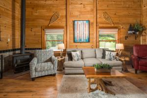 a living room with a couch and chairs and a fireplace at Serenity Summit in Banner Elk