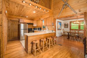 a kitchen with a bar and a dining room at Serenity Summit in Banner Elk +30 photos