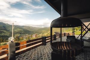 a balcony with a bench and a view of mountains at Panoramic Residence in Borşa +62 photos