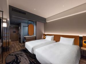 a hotel room with two beds and a mirror at Novotel Nara in Nara +193 photos