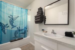 a bathroom with a sink and a shower curtain at The Hitching Post Motel in Pemberton +22 photos