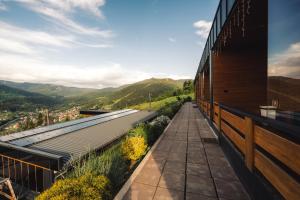 a view from the balcony of a house with mountains in the background at Panoramic Residence in Borşa