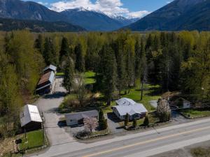 an aerial view of a house with trees and a road at The Hitching Post Motel in Pemberton