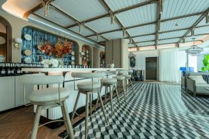 a bar in a room with stools at Serenity by Pavol in Ban Bo Han