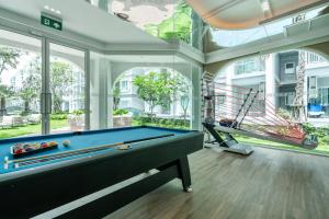 a pool table in a room with windows at Serenity by Pavol in Ban Bo Han