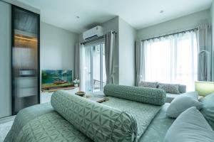 a living room with a couch and a large window at Serenity by Pavol in Ban Bo Han +49 photos