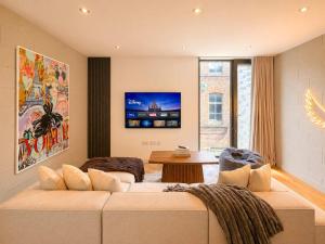 a living room with a couch and a table at Luxury Townhouse 4BR I Roof Terrace I Free Parking in Manchester