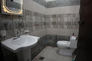 a bathroom with a sink and a toilet at Royal Cottage in Murree in Murree +20 photos