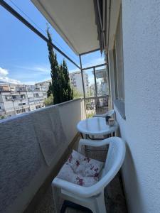 a small balcony with a table and a chair at Bar City Apt in Bar