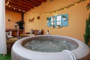 a hot tub in the middle of a living room at Casas Rurales Florentino in Robledillo