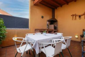 a white table and chairs on a patio at Casas Rurales Florentino in Robledillo