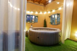 a large tub in a bathroom with green grass at Casas Rurales Florentino in Robledillo