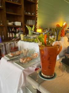 a table with a drink on a counter with food at Hotel Klaus in Opelousas