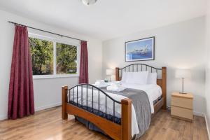 a bedroom with a bed and a window at The Hitching Post Motel in Pemberton