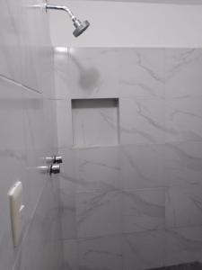 a bathroom with a shower with a toilet and a urinal at Casa León in Bacalar +19 photos