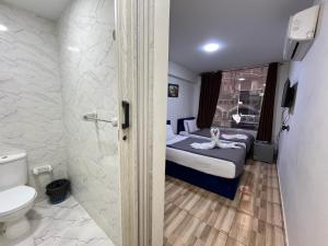 a small bathroom with a bed and a toilet at The Rivénto Boutique with Breakfast - Downtown,Cairo in Cairo +63 photos