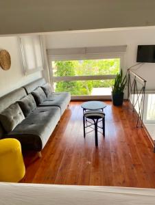 a living room with a couch and a table at A & D Houses No2 in Patra