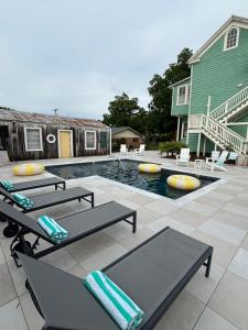a patio with two tables and a swimming pool at Hotel Klaus in Opelousas