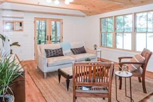 a living room with a couch and a table at Lake Winni Cottage in Moultonborough +18 photos