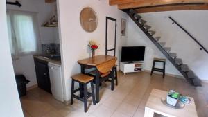 a living room with a table and a staircase at Kilomètre creusois in Saint-Dizier-Leyrenne