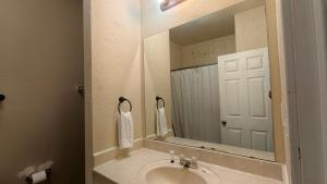 a bathroom with a sink and a large mirror at Studio 7 By Capital O Killeen I-14 in Harker Heights +56 photos