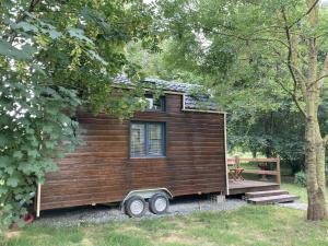 a tiny house on a trailer in the woods at Tiny House Insolite avec Escape Game in Chanzeaux