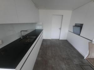 a kitchen with a sink and a counter top at Zimmer 2, Haus der Begegnung in Goldingen