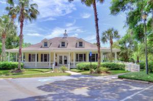 a house with palm trees on a street at Ocean Walk H-14 in Saint Simons Island