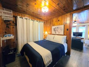 a bedroom with a bed in a wooden room at #08 - One Bedroom Lakeview Cottage-Pet Friendly in Hot Springs