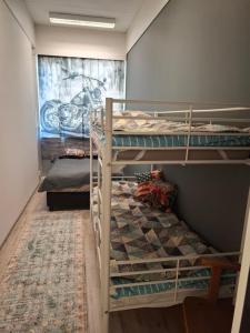 two bunk beds in a room with a mural at Schools Out OY in Loviisa