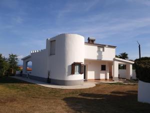 a large white house with a yard at Capomare2 in Capo Vaticano