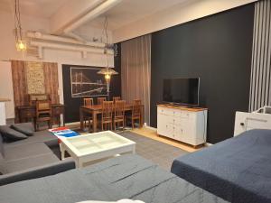 a living room with a couch and a tv at Schools Out OY in Loviisa